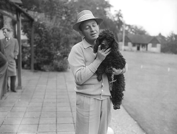 Bing Crosby holding a Poodle Sept 1952 A©Mirrorpix