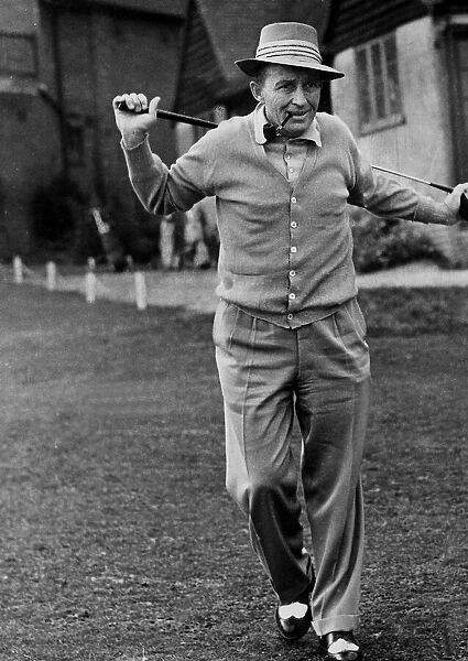 Bing Crosby with pipe contemplates next golf shot 1952