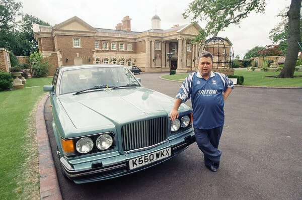 Birmingham City chairman David Sullivan pictured beside his Bently car at his home
