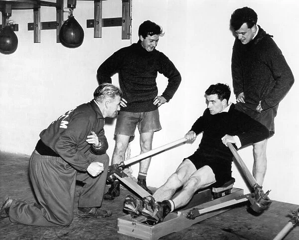 Birmingham City footballer Eddie Brown takes the strain on the rowing machine watched by