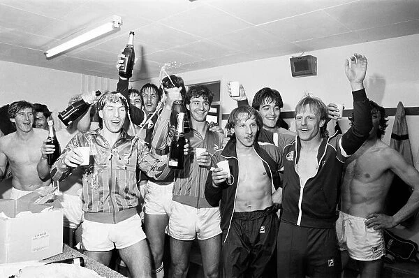 Birmingham City players celebrate with champagne in the dressing room after they clinched