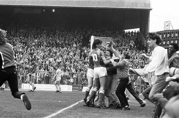 Birmingham City players mobbed by jubilant fans who have run onto the pitch as they