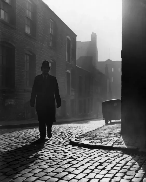 Framed Print : Birmingham Emergency Services. A police officer walking on the beat in the early