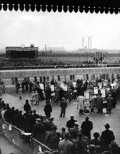 Birmingham Race Course. Crowds gather at the rails to watch the next race