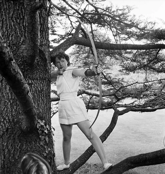 Bisham Abbey Physical recreation centre. A woman in one of the trees on the lawns in