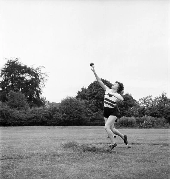 Bisham Abbey Physical Recreation Centre. Woman throwing the shotput. June 1952 C3238-003