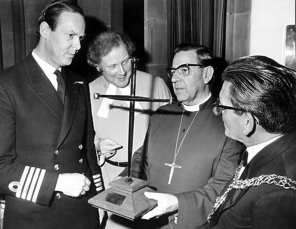 The Bishop takes charge of the cross of nails. With him are (from left), Capt