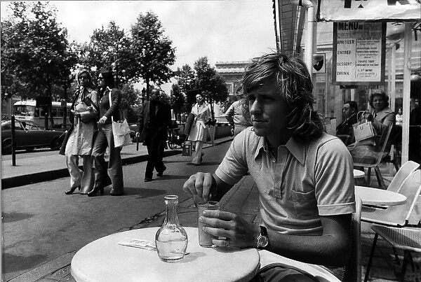 Bjorn Borg tennis player sitting in a cafe on the Champs Elysee in Paris having a drink