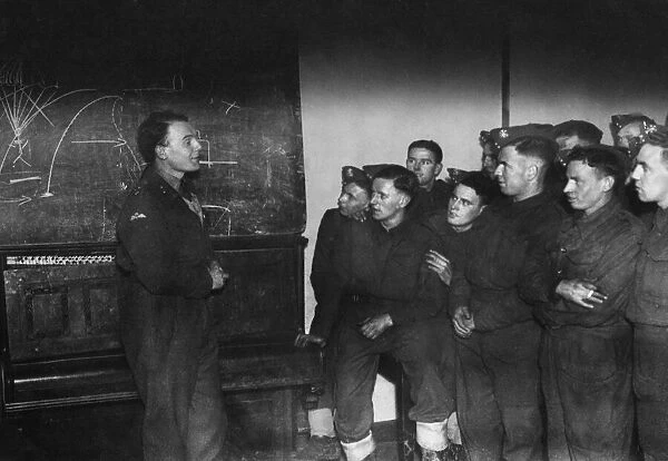 A blackboard lecture on parachutists by Lieutenant Ewart Evans to men of the Welch