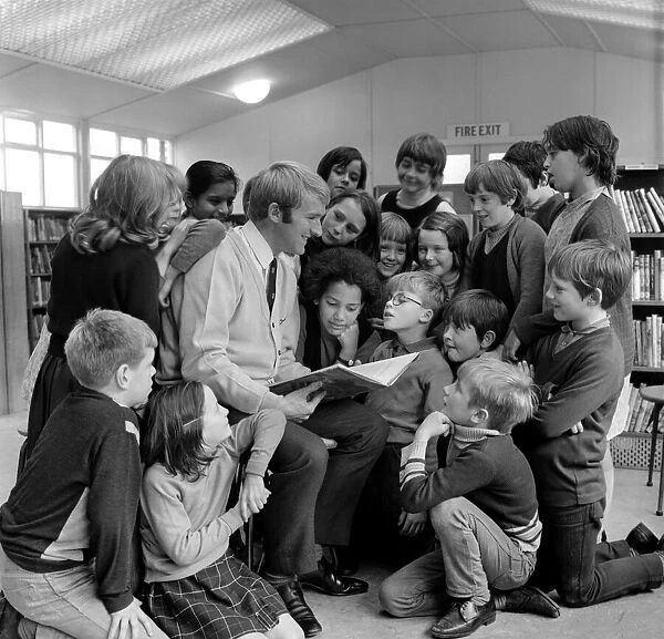Blackburn Rovers footballer Ken Knighton pictured reading stories to a group of children