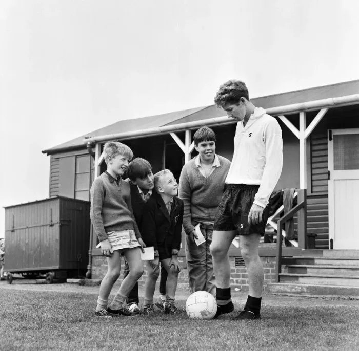 Framed Print : Blackpool and England footballer Alan Ball at the training ground with young autograph