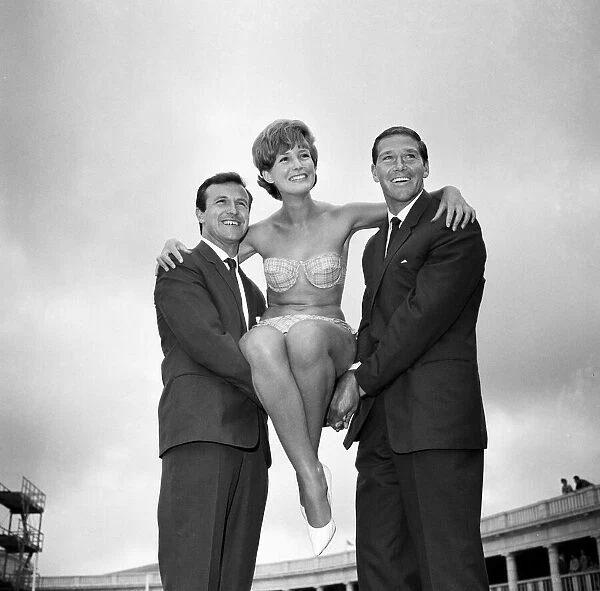 Blackpool footballer Jimmy Armfield (left) and Tony Waiters hoist up eighteen year old