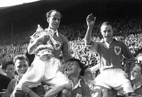 Blackpool footballer Stanley Matthews is carried on the shoulders of his team mates as
