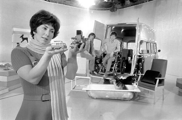 Blue Peter television presenter Val Singleton holds up some of the toy cars which will go