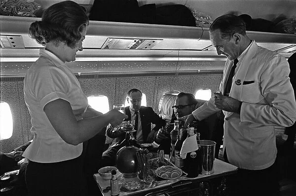 BOAC Steward and Stewardess serving drinks during a proving flight between Heathrow