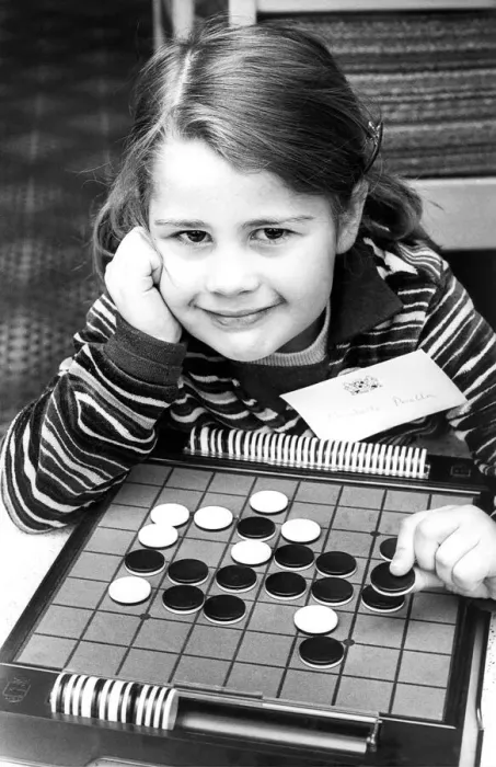 Framed Print : The board game Othello is childs play to four year old Elizabeth Perella in April 1977