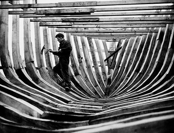 Boat building at Girvan Ayrshire December 1947 Andrew Ollason works with his axe