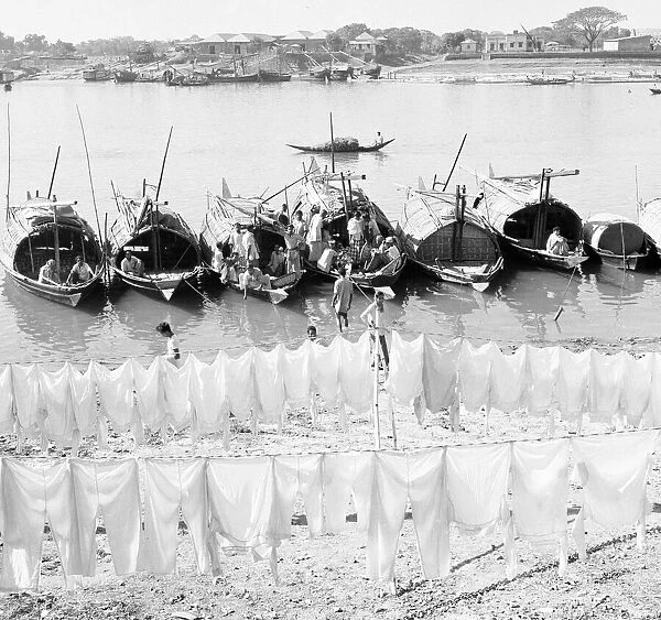 Boat people seen here hanging their washing out to dry on the muddy beach in Dacca