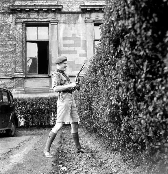 Bob-a-job week April 1953. John Jackson, boy scout seen here cutting the hedge of