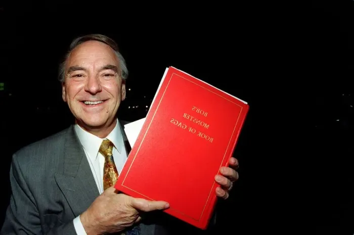 Framed Print : Bob Monkhouse Comedian / TV Presenter holding the book of gags that was stolen from his Framed Print : Bob Monkhouse Comedian / TV Presenter holding the book of gags that was stolen from his