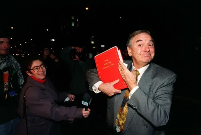 Framed Print : Bob Monkhouse Comedian  /  TV Presenter November 1996. Holding the book of gags that