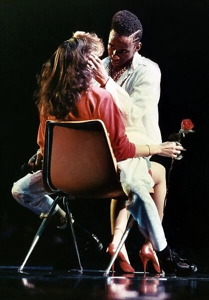 Bobby Brown soul singer on stage with a woman June 1989