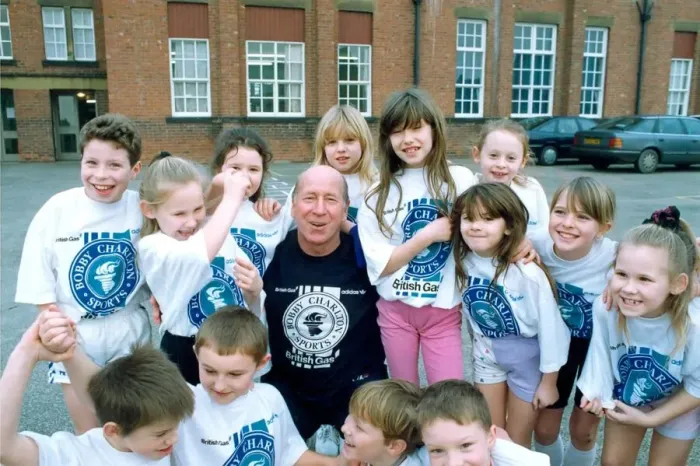 Framed Print : Bobby Charlton with children from Cavendish First School in Ashington in January 1992 Framed Print : Bobby Charlton with children from Cavendish First School in Ashington in January 1992