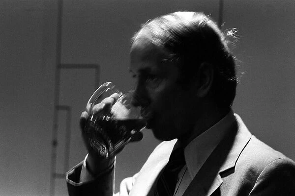 Bobby Charlton enjoys a pint at a bar in the players lounge at Old Trafford