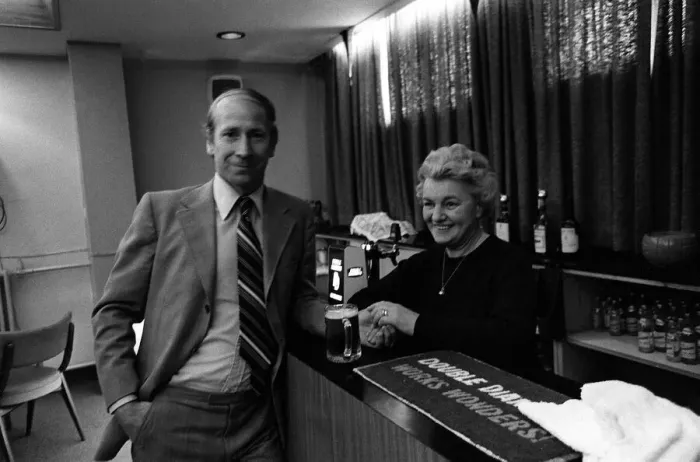 Framed Print : Bobby Charlton enjoys a pint at a bar in the players lounge at Old Trafford