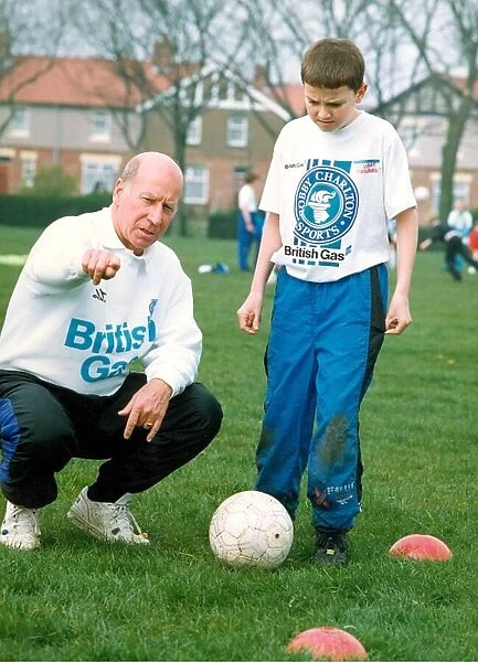 Bobby Charlton gives some advice to youngsters who turned up to see him on is one day