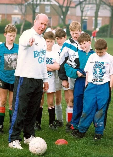 Bobby Charlton gives some advice to youngsters who turned up to see him on is one day