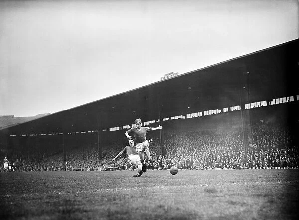Bobby Charlton leaps to elude a defender during the match between Manchester United