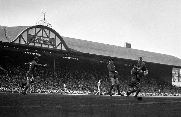 Bobby Charlton of Manchester United crashes in to Liverpool player Tommy Smith after