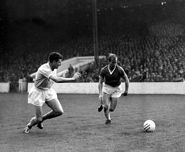 Bobby Charlton of Manchester United in a race for the ball with Manchester City