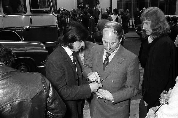 Bobby Charlton of Manchester United signs autograph 1971 for a fan