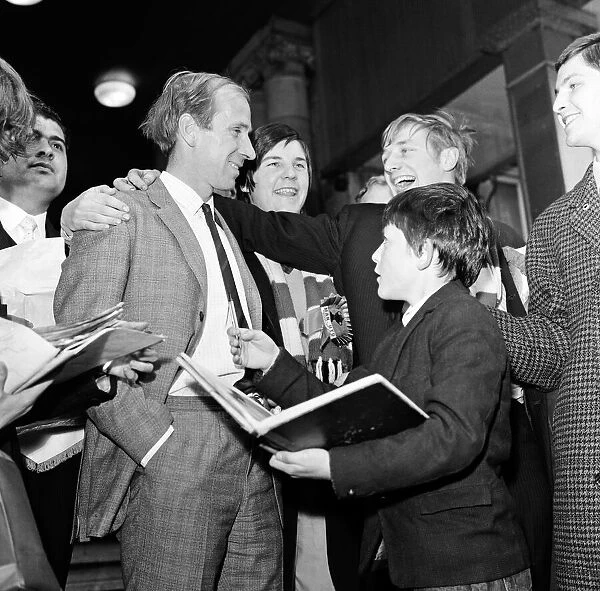 Bobby Charlton is smothered by fans wanting his autograph Manchester United