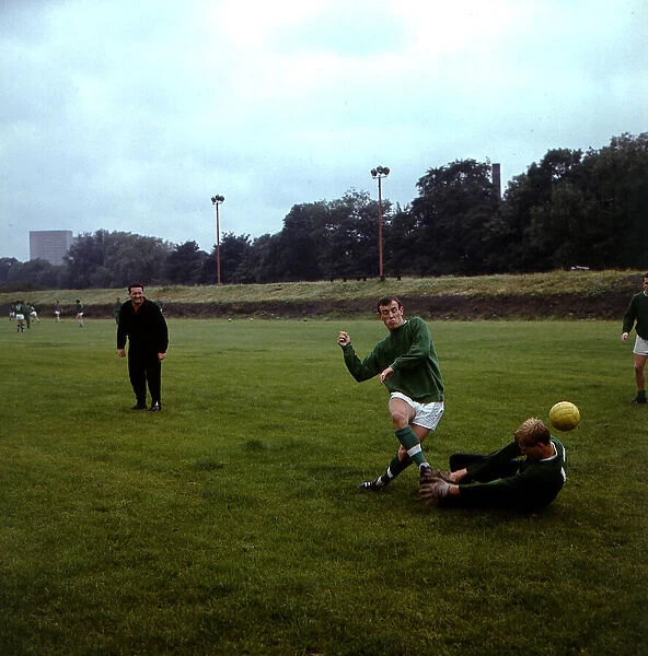 Bobby Lennox footballer Celtic FC during training shooting past goalkeeper Bent Martin