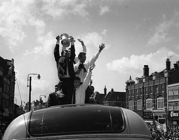 Bobby Moore holds up the FA Cup during the parade around East London after the Hammers