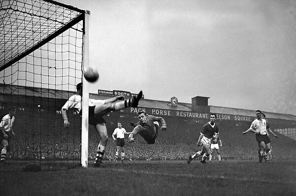 Bolton Wanderers goalkeeper Hopkinson dives across his goal as a defender clears away a