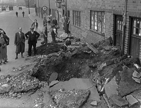 A bomb crater in Bromford Road, Birmingham following a raid on the city. 14th August 1940