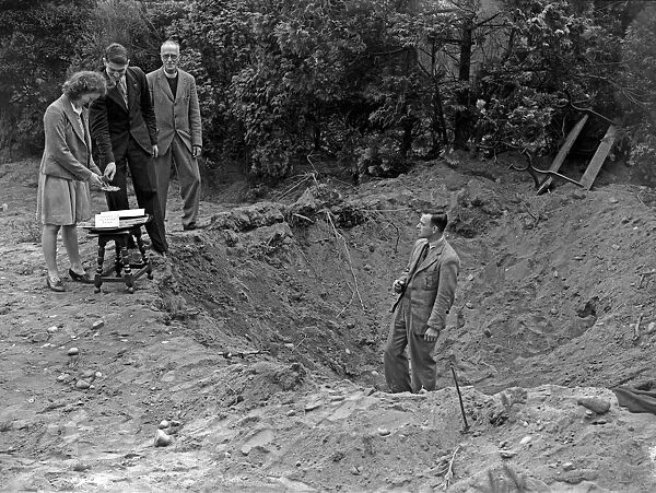 This bomb crater in a vicarage garden was caused by last nightOs Nazi raiders