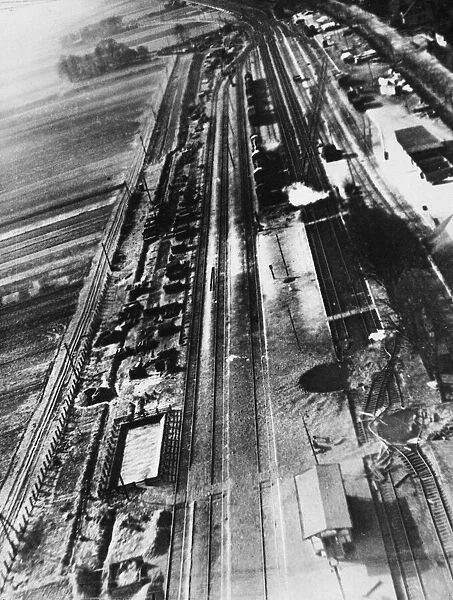 Bomb craters can be seen severing the central platform of the railway station at