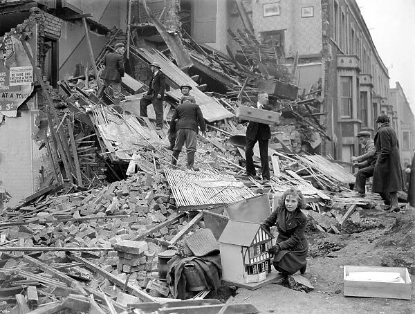 Bomb Damage at Bristol. A young girl who has salvaged her dolls house