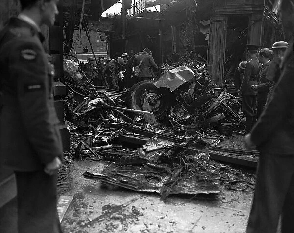 Bomb damage to building during WW2, with rescuers on the scene to survey the damage