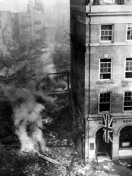 Bomb damage to buildings in High Street, Coventry. Martins Bank is to the right of