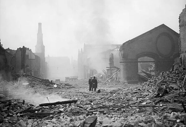 Bomb damage at Liverpool. Two people survey the damage caused by an air raid
