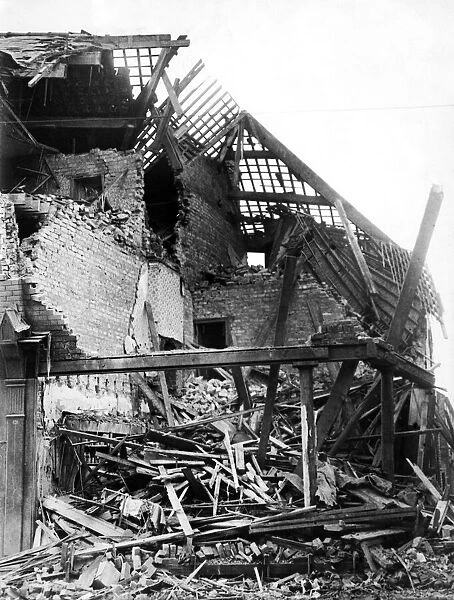 Bomb damage in Wavertree Road, Liverpool. This shop and house was the victim of a direct