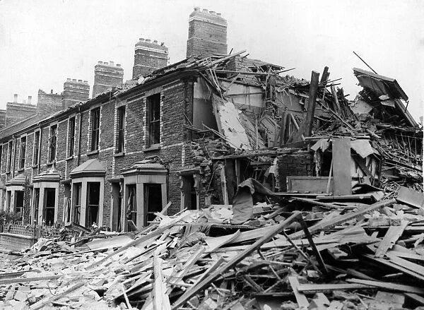 Bomb damage to workmens dwellings in a South Wales town. 1st July 1941