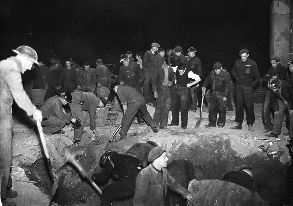 A bombed school near London. Rescue workers at night