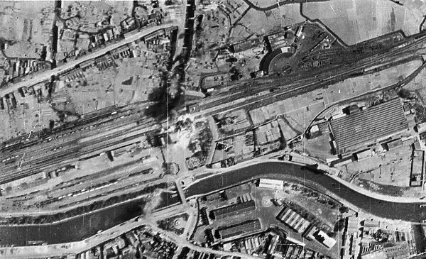 Bombs bursting on the railway station and sidings during a daylight attack by RAF Bomber